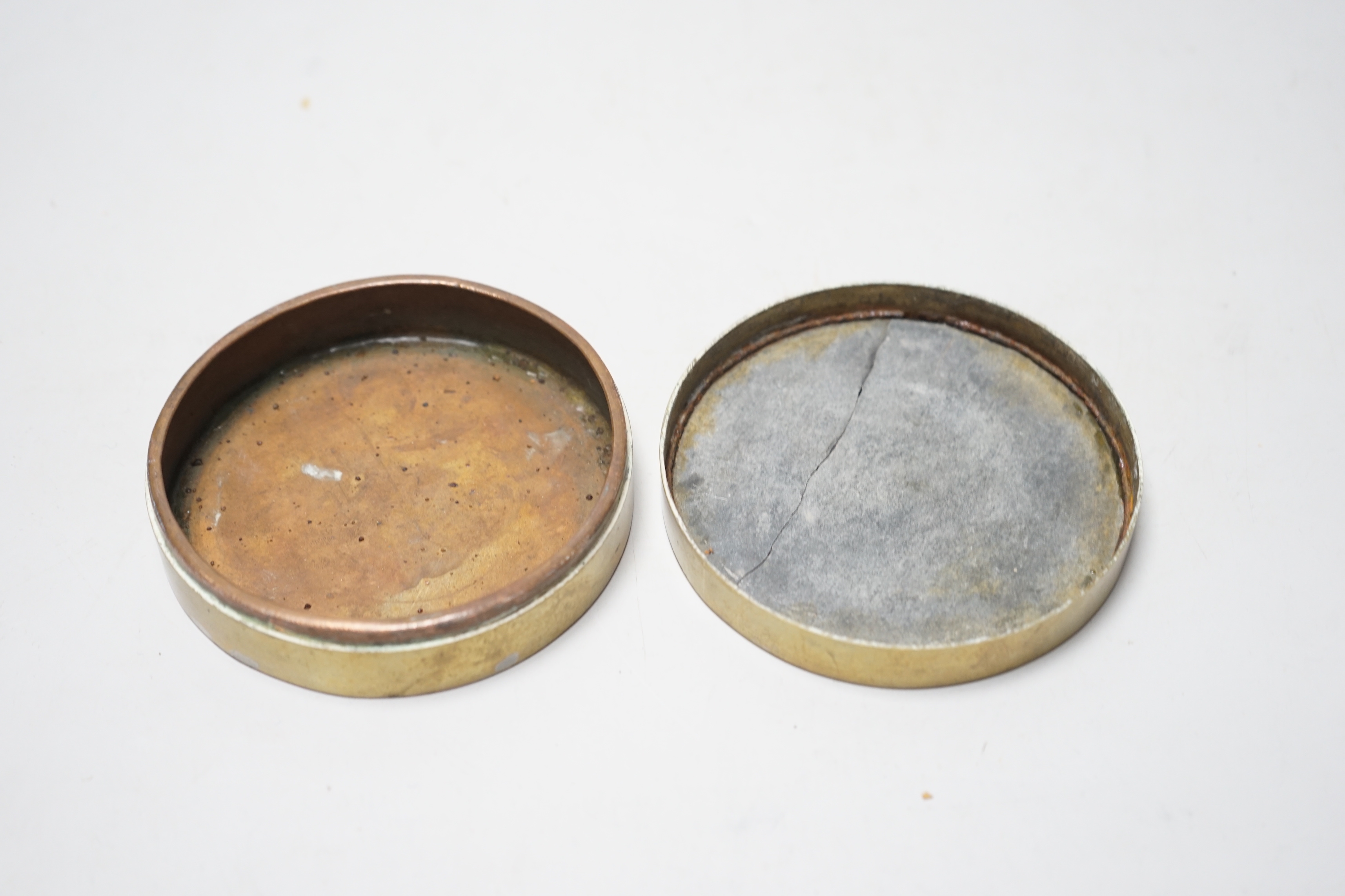 A Chinese paktong inscribed circular ink box, late 19th/early 20th century, 10cm in diameter